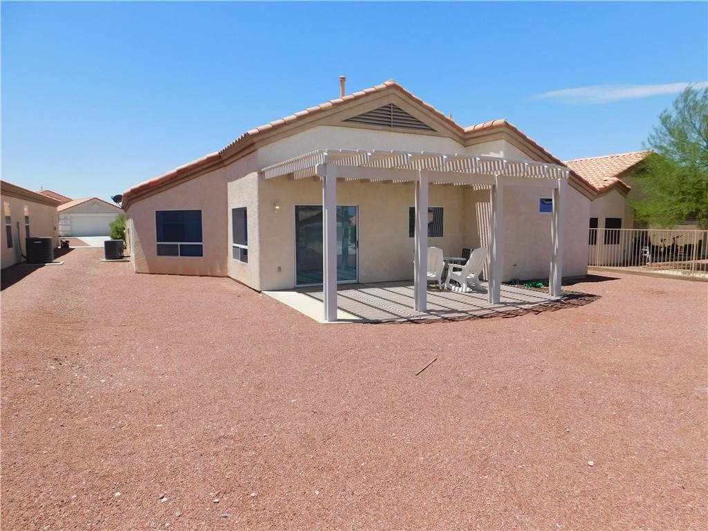 2449 Wilder Road Bullhead City, AZ 86442 - Photo 10 of 45 a view of a house with a yard and large tree