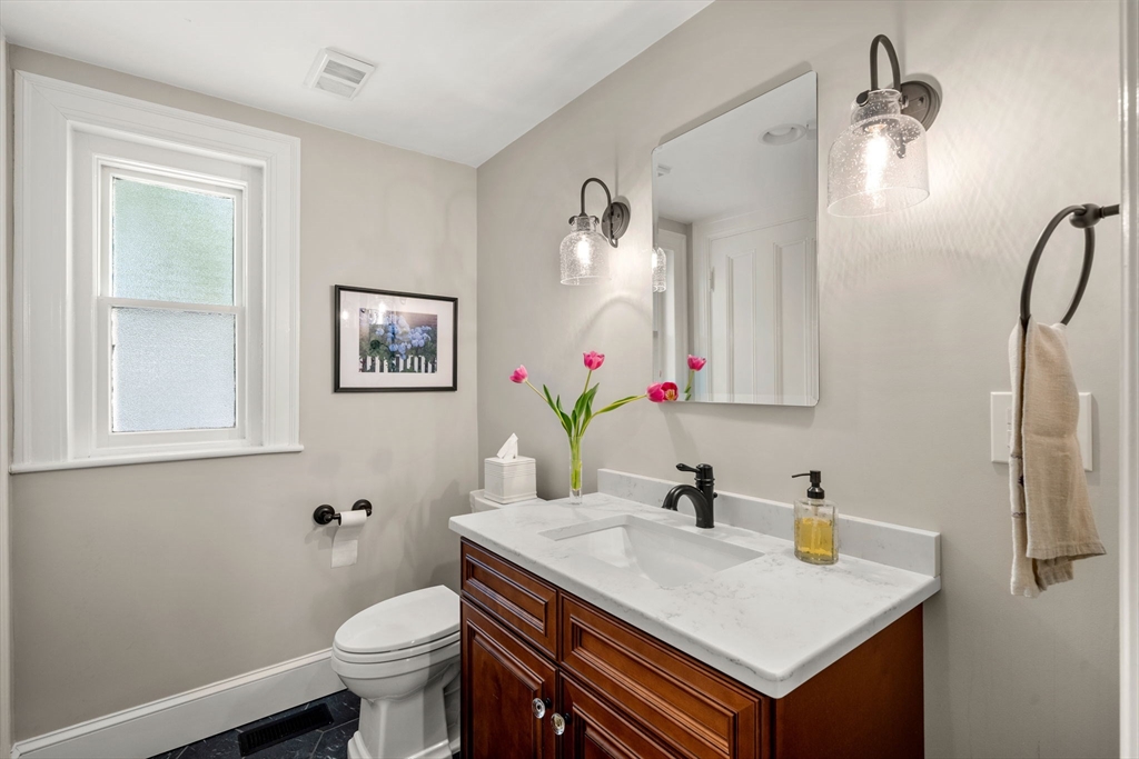 44 Pleasant Street, Unit 1 Marblehead, MA 01945 - Photo 13 of 35 a bathroom with a sink toilet and mirror