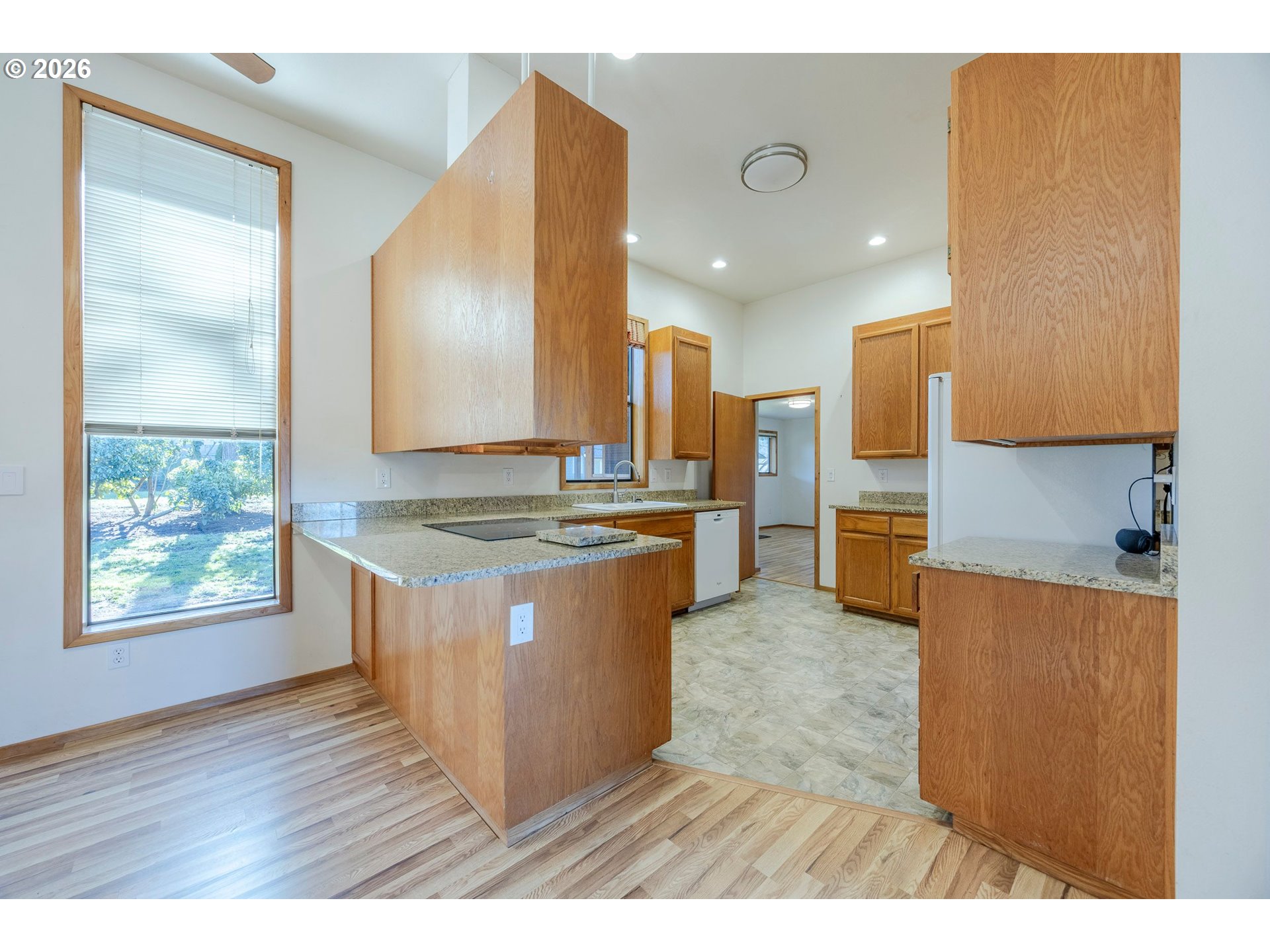 3248 West 15th Avenue Eugene, OR 97402 - Photo 14 of 33 a kitchen with kitchen island granite countertop a sink stove and refrigerator