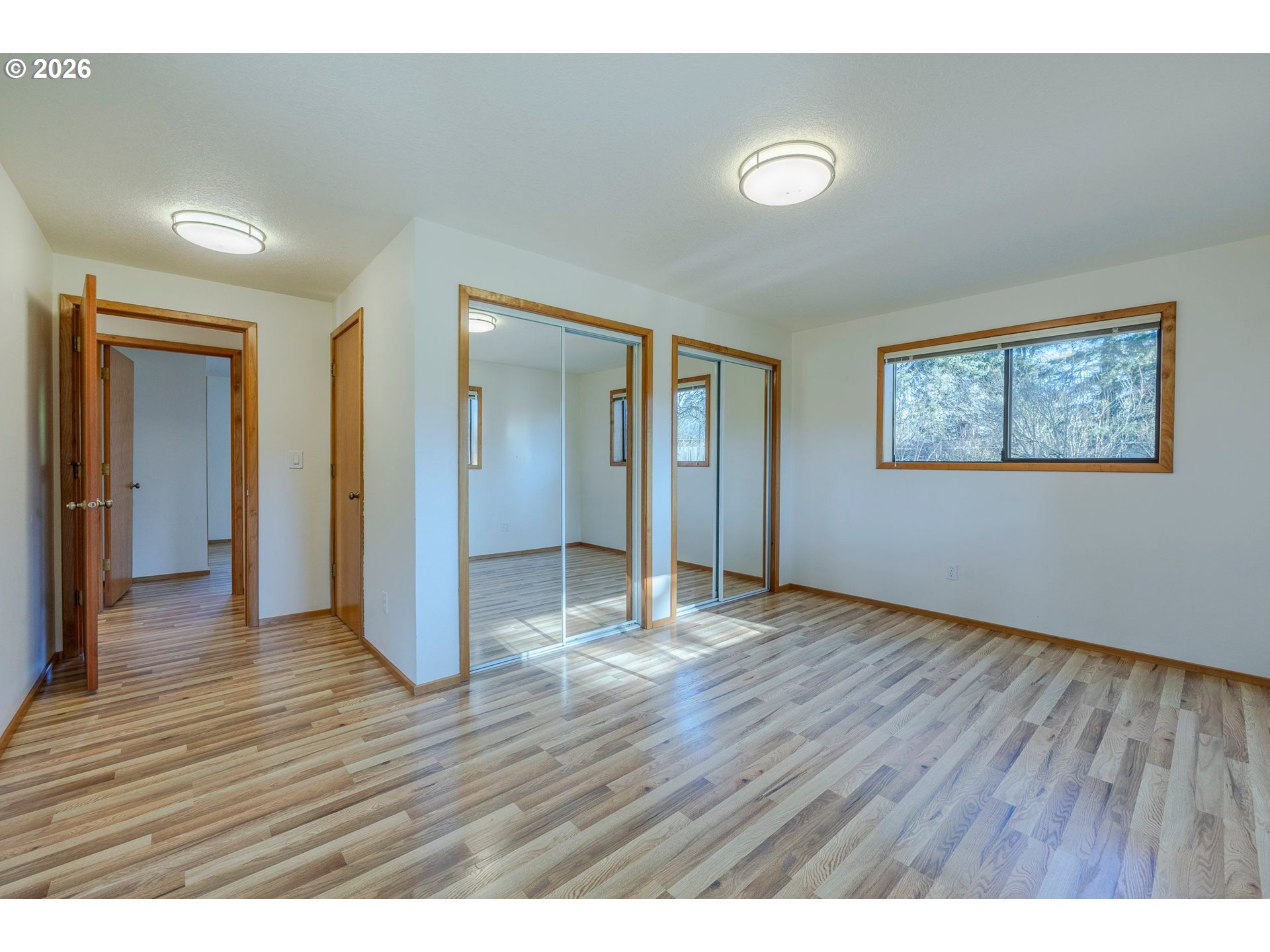 3248 West 15th Avenue Eugene, OR 97402 - Photo 22 of 33 a view of an empty room with wooden floor and closet