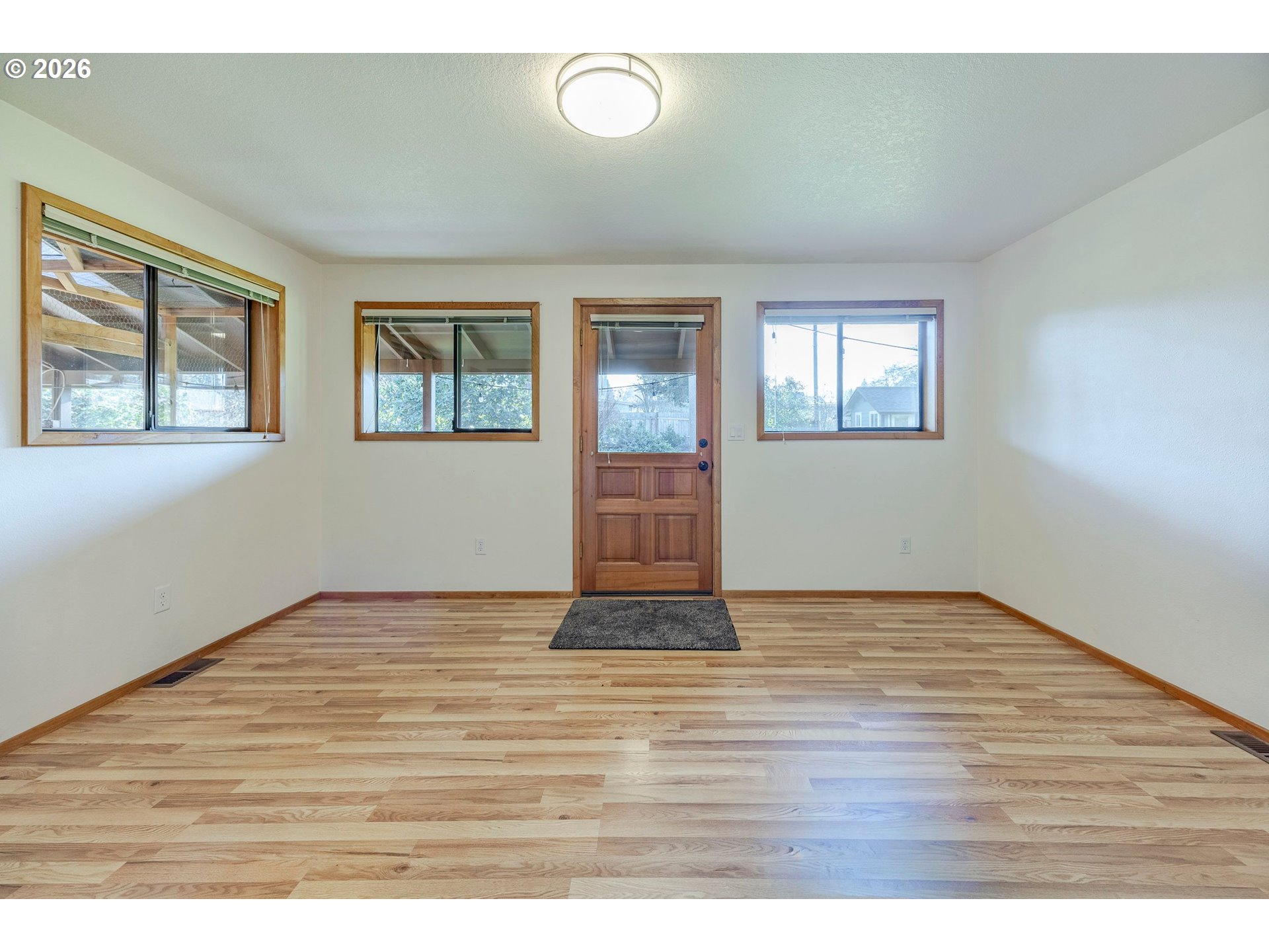 3248 West 15th Avenue Eugene, OR 97402 - Photo 30 of 33 a view of an empty room with wooden floor and a window
