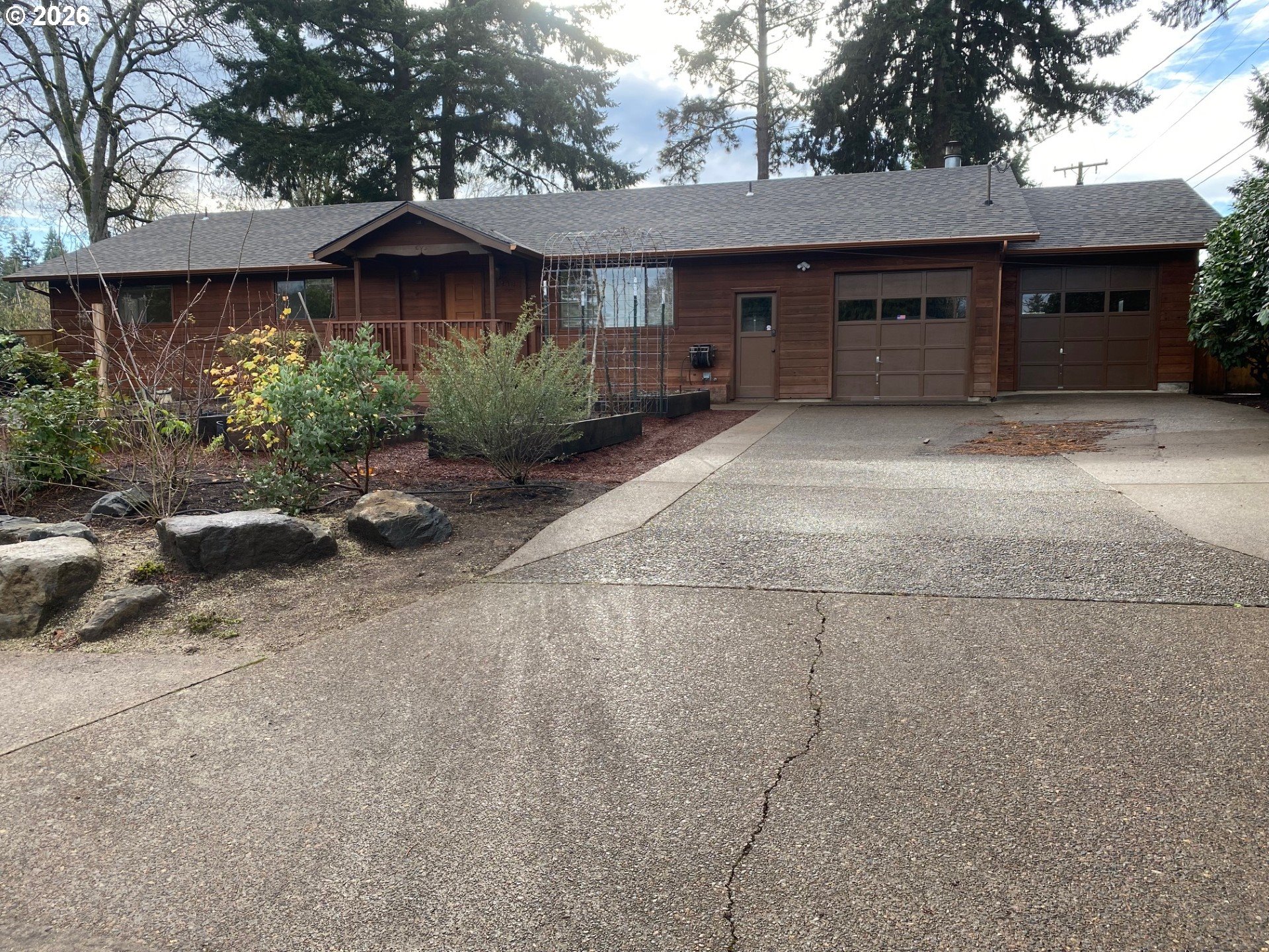 3248 West 15th Avenue Eugene, OR 97402 - Photo 5 of 33 a front view of a house with a yard and garage