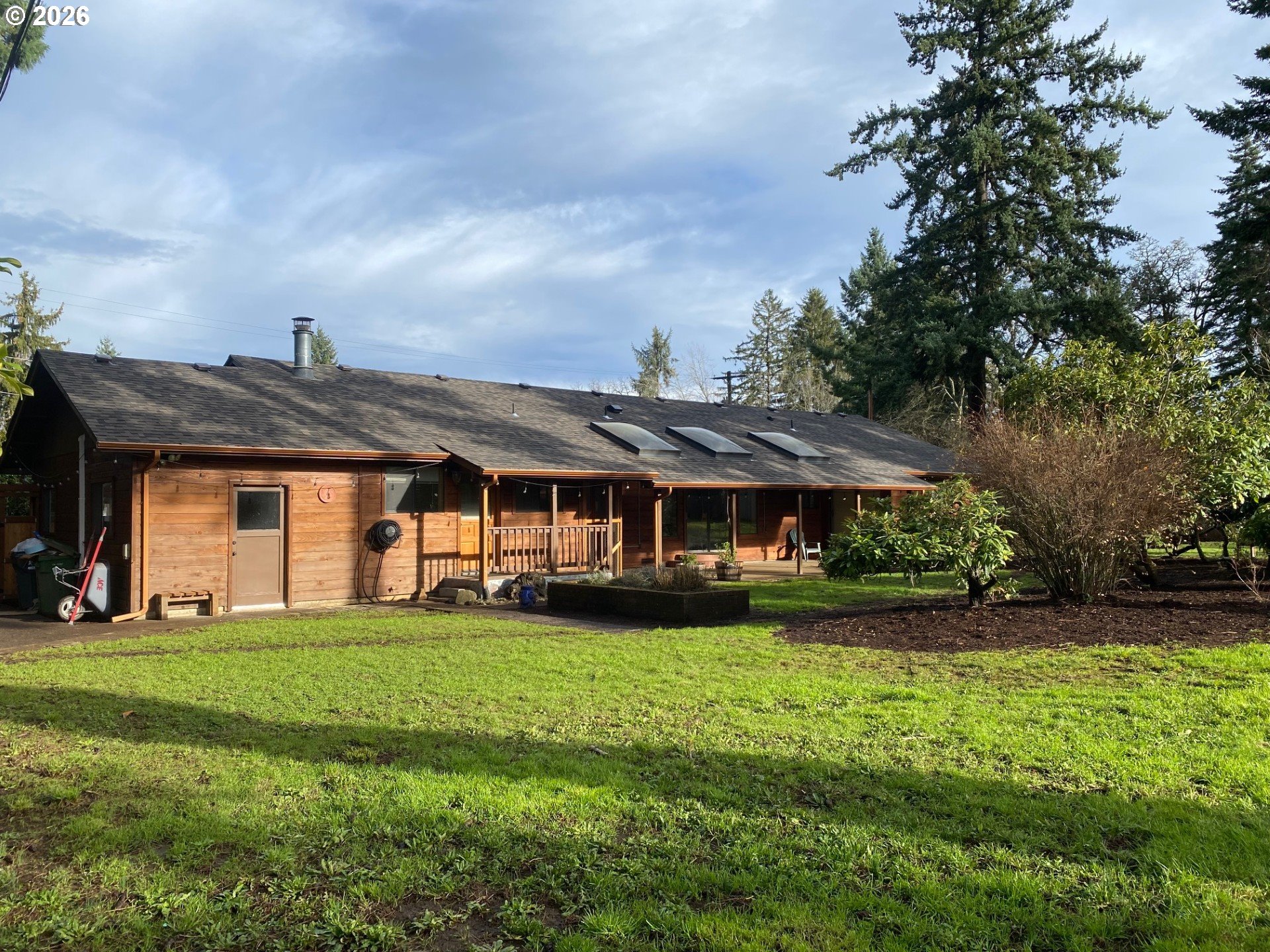 3248 West 15th Avenue Eugene, OR 97402 - Photo 7 of 33 a view of a house with a big yard and potted plants