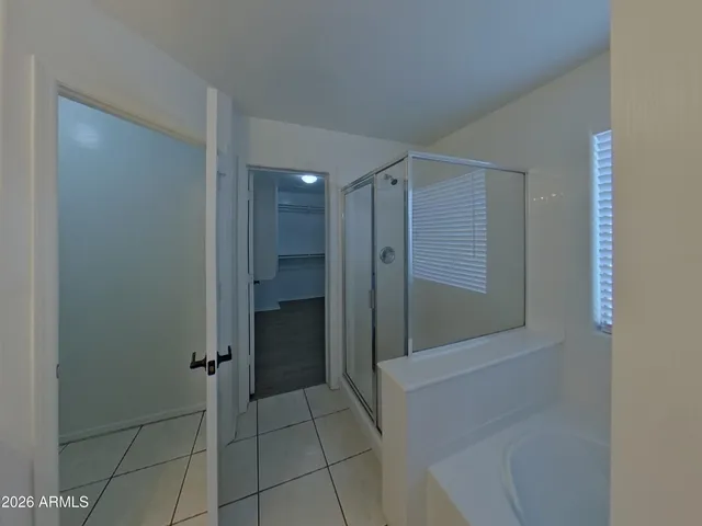 a bathroom with a shower and closet
