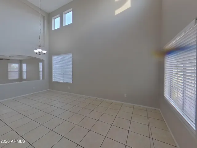 a view of a livingroom with an empty space and a window