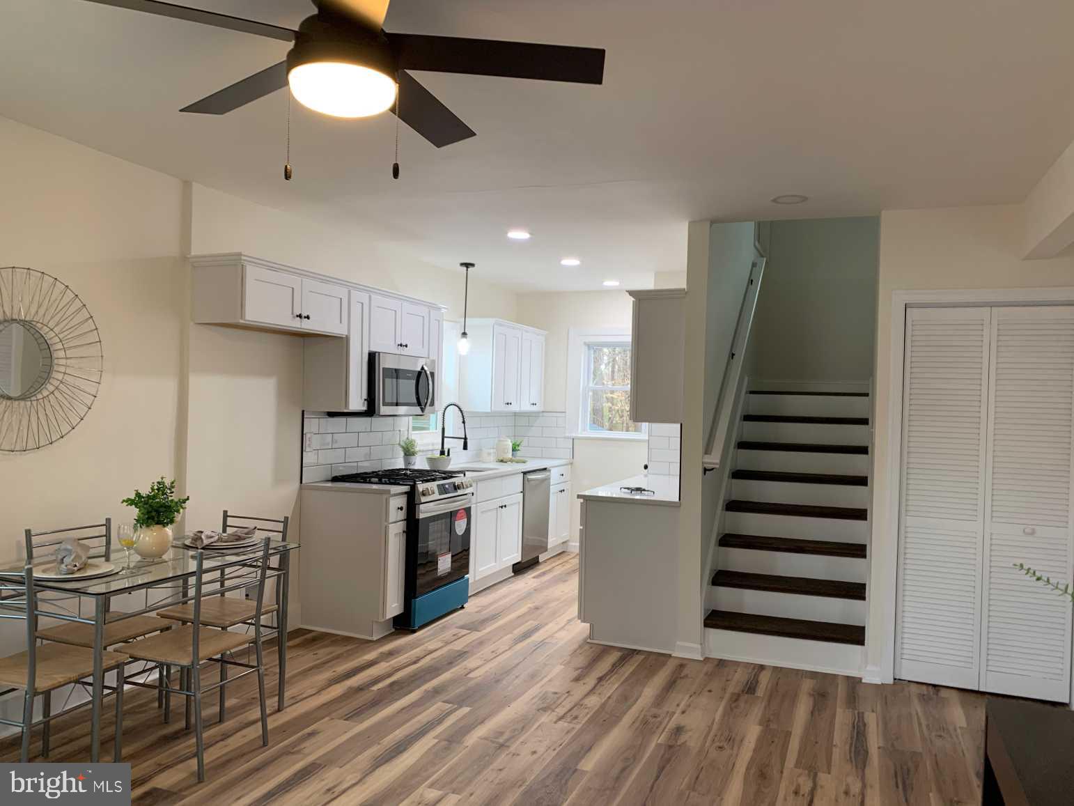 12 Johnson Avenue Seaford, DE 19973 - Photo 5 of 16 a kitchen with stainless steel appliances a stove a refrigerator and wooden floors