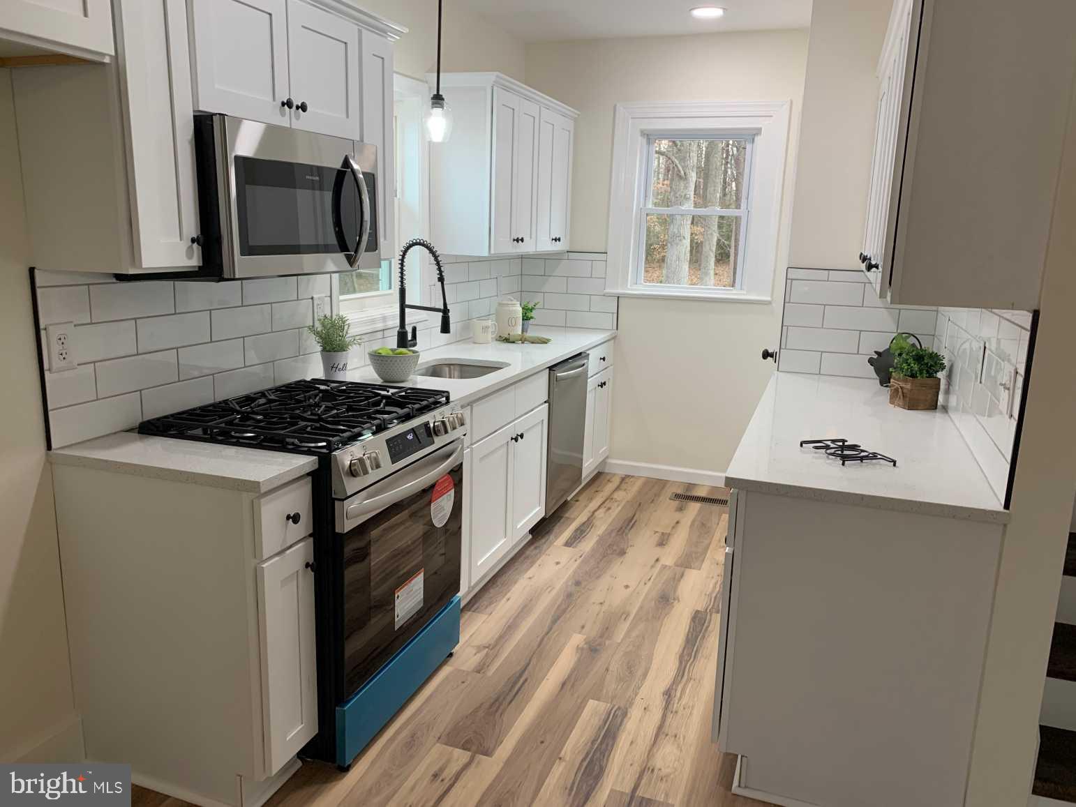 12 Johnson Avenue Seaford, DE 19973 - Photo 6 of 16 a kitchen with stainless steel appliances a stove a sink a refrigerator a microwave counter space and cabinets