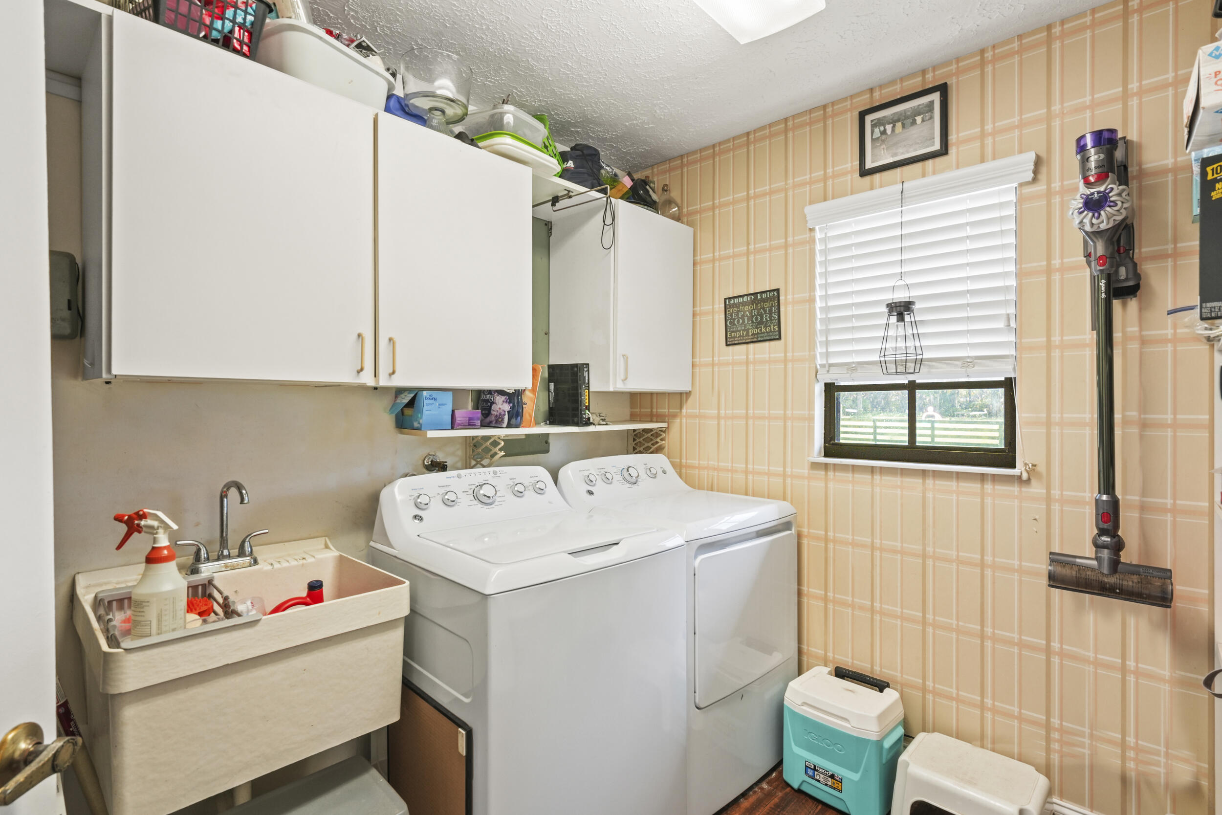 4170 McCarty Road Fort Pierce, FL 34945 - Photo 36 of 57 a utility room with dryer washer and a window