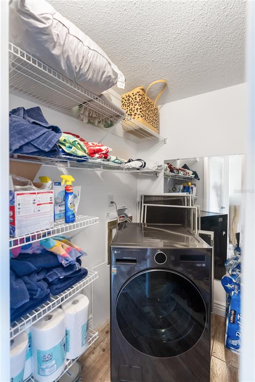1750 Benjamin Franklin Drive, Unit 6G Sarasota, FL 34236 - Photo 18 of 82 a utility room with stove and lots of wooden furniture