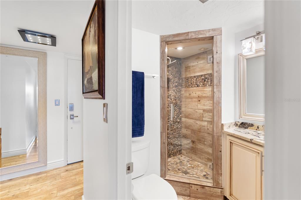 1750 Benjamin Franklin Drive, Unit 6G Sarasota, FL 34236 - Photo 19 of 82 a bathroom with a shower and a mirror