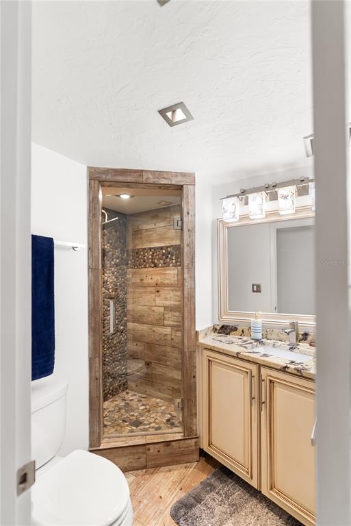 1750 Benjamin Franklin Drive, Unit 6G Sarasota, FL 34236 - Photo 20 of 82 a bathroom with a granite countertop toilet sink and shower