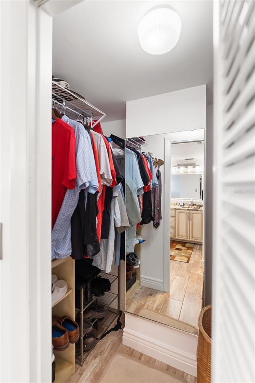 1750 Benjamin Franklin Drive, Unit 6G Sarasota, FL 34236 - Photo 23 of 82 a view of walk in closet with clothes and shoes