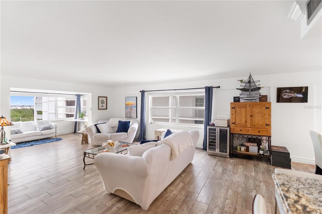 1750 Benjamin Franklin Drive, Unit 6G Sarasota, FL 34236 - Photo 33 of 82 a living room with furniture and a wooden floor