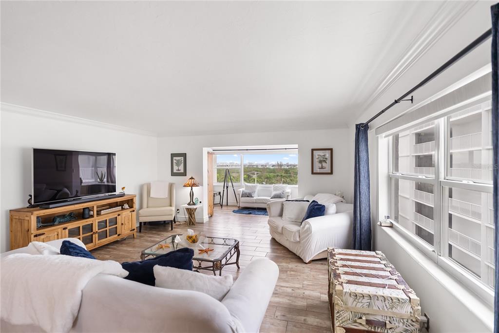 1750 Benjamin Franklin Drive, Unit 6G Sarasota, FL 34236 - Photo 34 of 82 a living room with furniture or couch and a flat screen tv