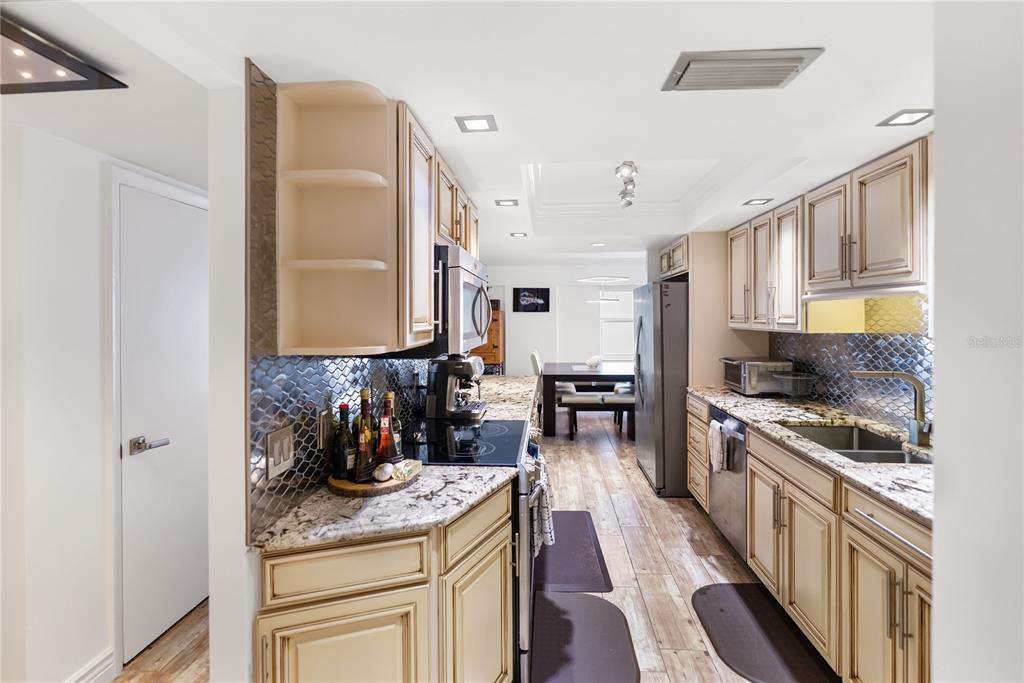 1750 Benjamin Franklin Drive, Unit 6G Sarasota, FL 34236 - Photo 35 of 82 a kitchen with stainless steel appliances granite countertop a stove a sink and a refrigerator