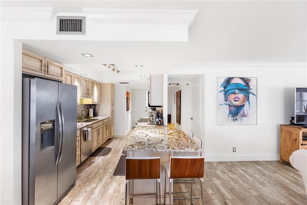1750 Benjamin Franklin Drive, Unit 6G Sarasota, FL 34236 - Photo 39 of 82 a kitchen with stainless steel appliances granite countertop a refrigerator and a stove top oven