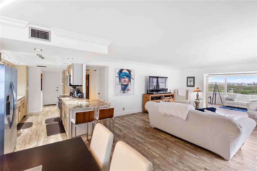 1750 Benjamin Franklin Drive, Unit 6G Sarasota, FL 34236 - Photo 42 of 82 a living room with furniture and a flat screen tv