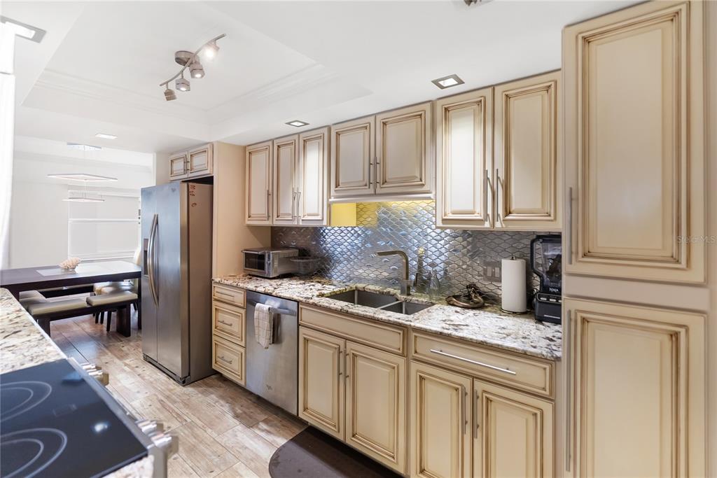 1750 Benjamin Franklin Drive, Unit 6G Sarasota, FL 34236 - Photo 5 of 82 a kitchen with stainless steel appliances granite countertop a stove a sink and a refrigerator