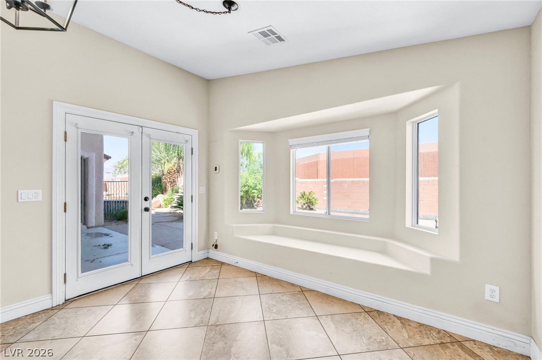 6405 North Raptor Court North Las Vegas, NV 89084 - Photo 20 of 66 Patio access and a charming window seat create an inviting space for relaxation.