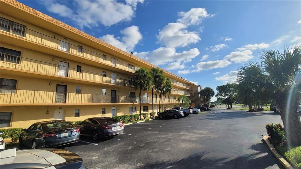 9273 Southwest 8th Street, Unit 109 Boca Raton, FL 33428 - Photo 16 of 20 a car parked in front of a building