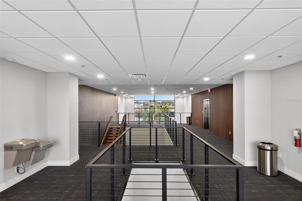 1711 Amazing Way, Unit 201 Ocoee, FL 34761 - Photo 12 of 15 a view of a hallway with wooden floor and staircase