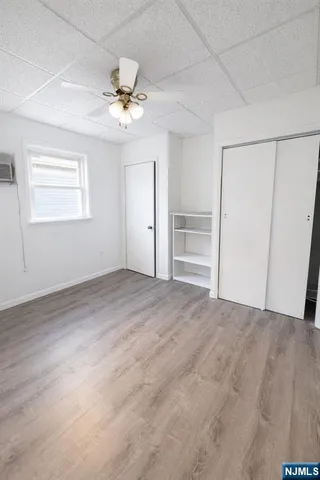 a view of a livingroom with a ceiling fan and window
