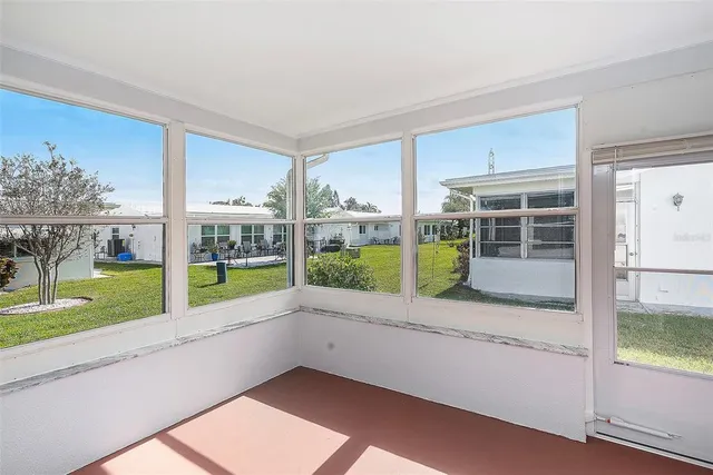 a view of a porch with furniture and garden