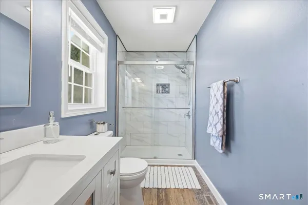 a bathroom with a sink toilet and shower