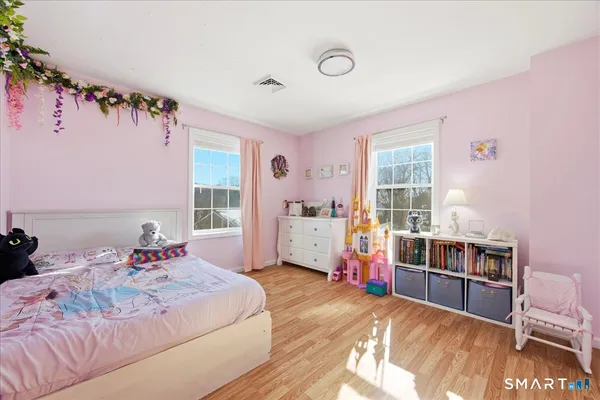 a bedroom with a bed and a large window