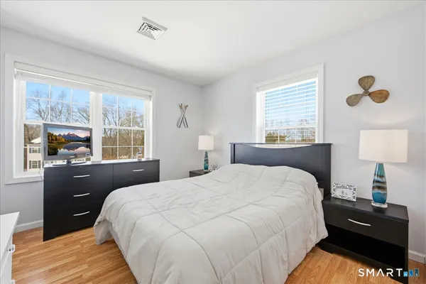 a bedroom with a bed and a window