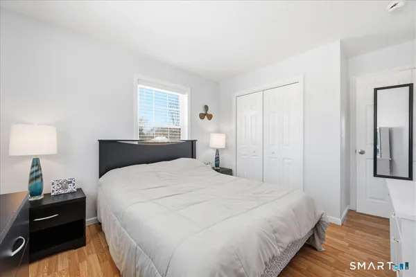 a bedroom with a bed and a lamp