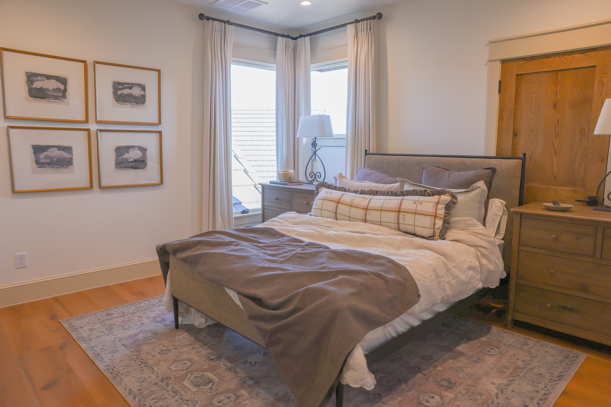 920 Ryan Road Bertram, TX 78605 - Photo 19 of 40 Rich wood flooring and large corner windows define this inviting bedroom space.