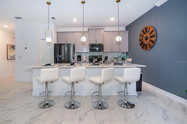 a kitchen with a sink cabinets and appliances