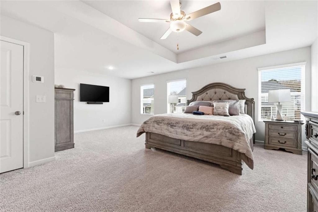 11817 Rizvan Place Covington, GA 30014 - Photo 18 of 40 a bedroom with a large bed and a window