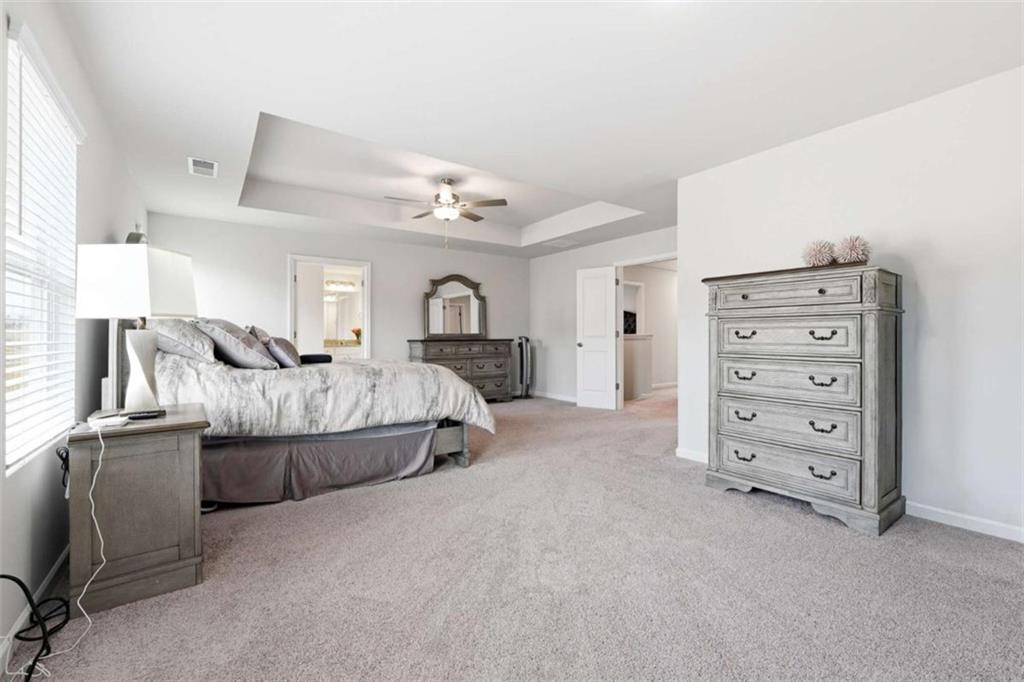11817 Rizvan Place Covington, GA 30014 - Photo 19 of 40 a living room with furniture and a dresser