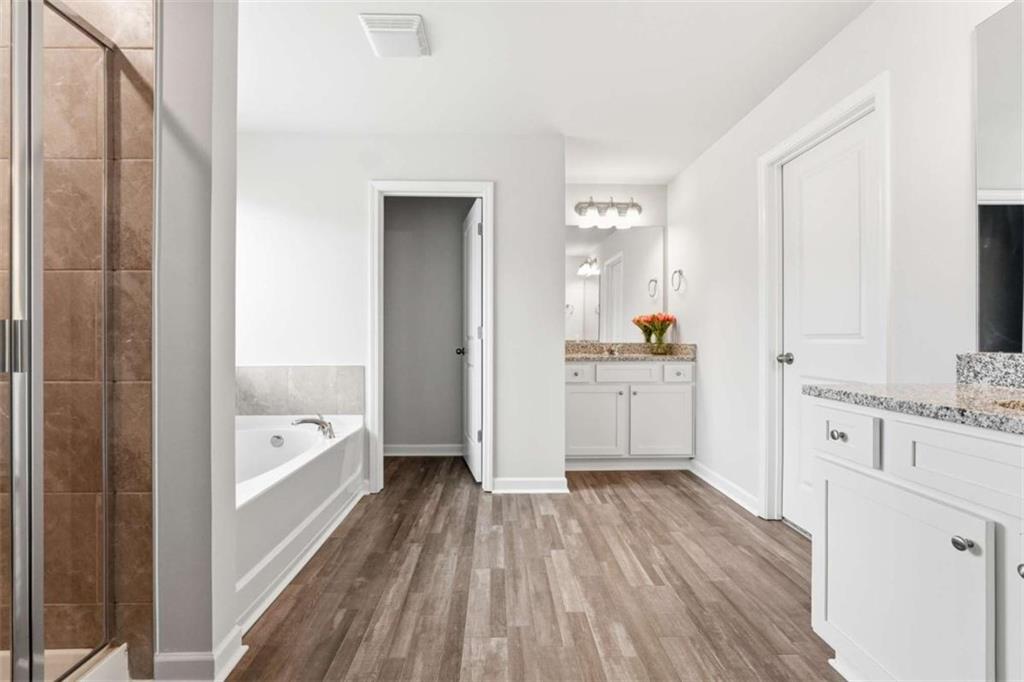 11817 Rizvan Place Covington, GA 30014 - Photo 21 of 40 a bathroom with a tub sink and mirror