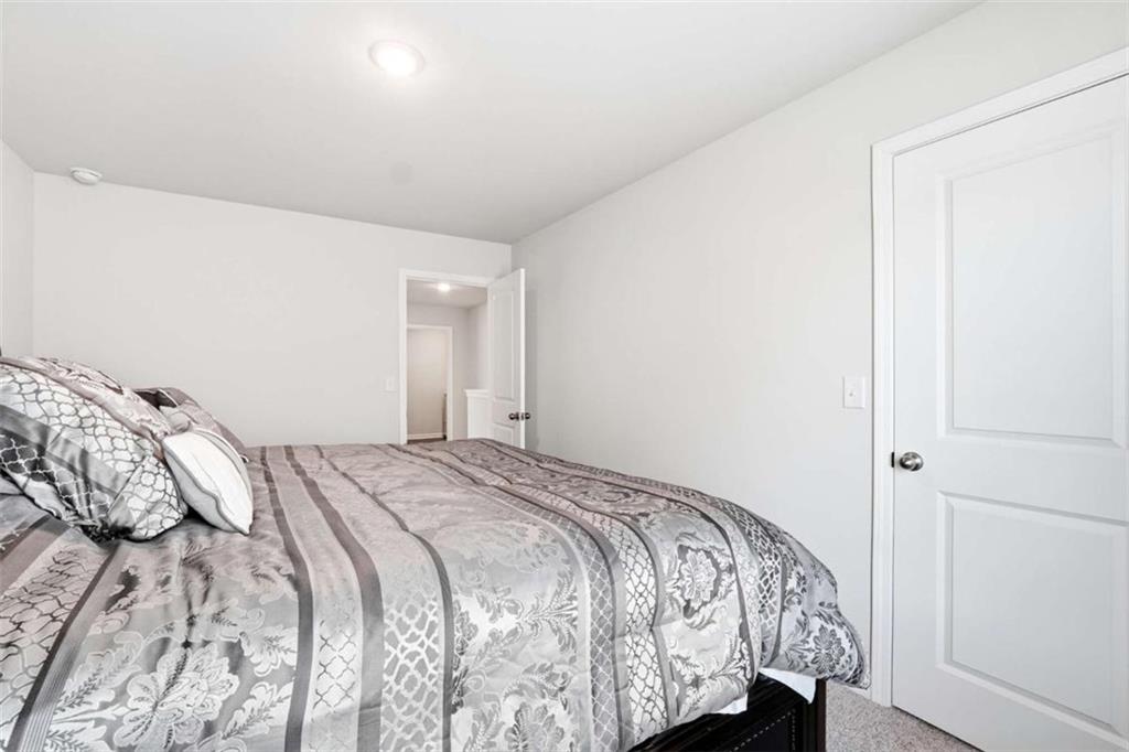 11817 Rizvan Place Covington, GA 30014 - Photo 28 of 40 a bedroom with a bed and a window