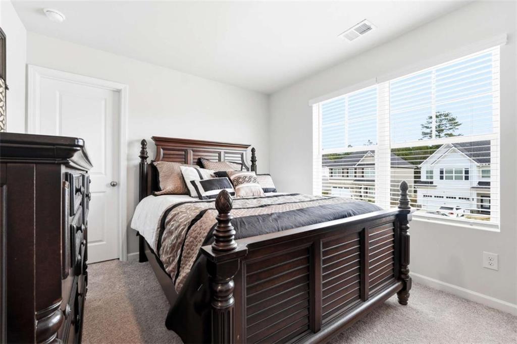 11817 Rizvan Place Covington, GA 30014 - Photo 29 of 40 a bed room with a bed and a window