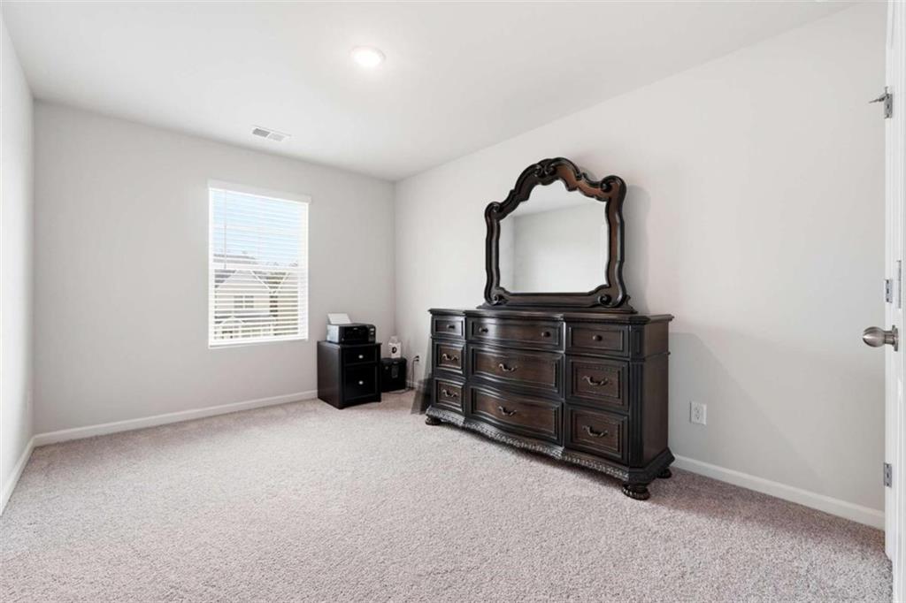 11817 Rizvan Place Covington, GA 30014 - Photo 30 of 40 an empty room with furniture and air conditioner vent