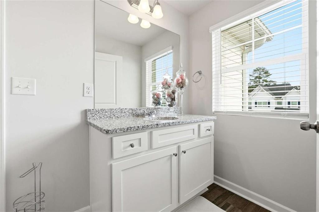 11817 Rizvan Place Covington, GA 30014 - Photo 31 of 40 a bathroom with a granite countertop sink and a mirror