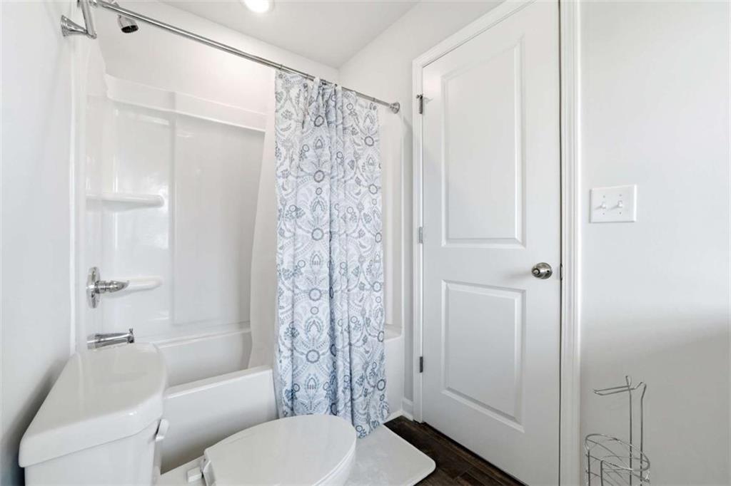 11817 Rizvan Place Covington, GA 30014 - Photo 32 of 40 a bathroom with a shower curtain a sink and a toilet