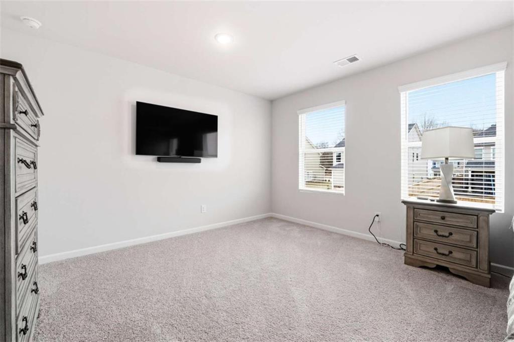 11817 Rizvan Place Covington, GA 30014 - Photo 33 of 40 a living room with furniture and a flat screen tv