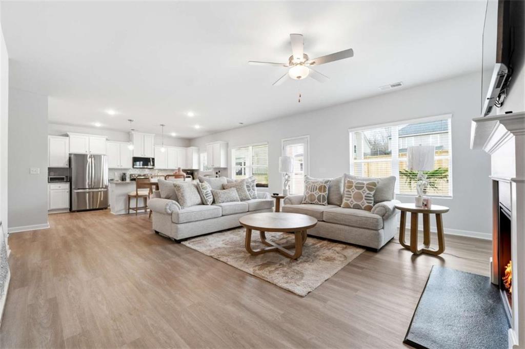 11817 Rizvan Place Covington, GA 30014 - Photo 5 of 40 a living room with furniture and a large window