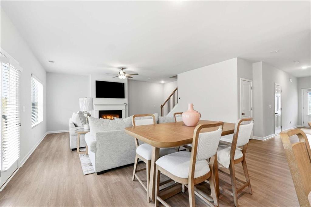 11817 Rizvan Place Covington, GA 30014 - Photo 10 of 40 a dining room with furniture and wooden floor