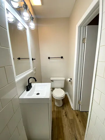 a bathroom with a sink a toilet and a mirror