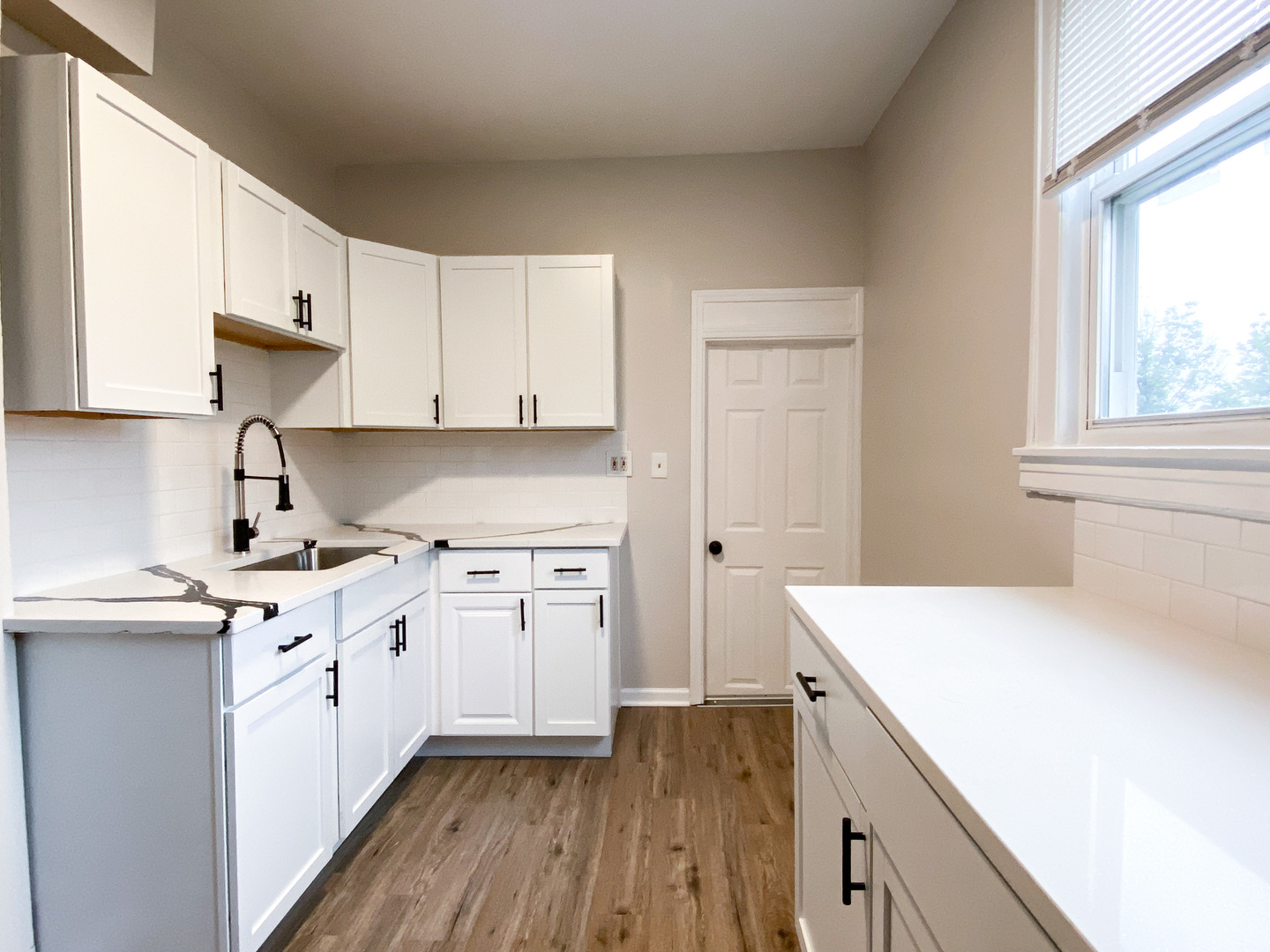 8933 South Halsted Street Chicago, IL 60620 - Photo 5 of 10 a kitchen with a sink a stove and cabinets
