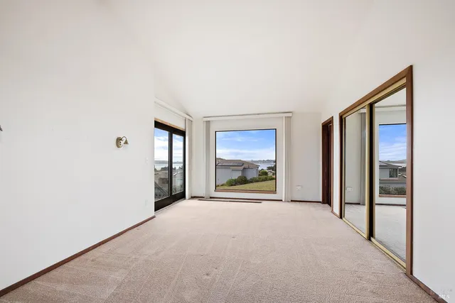 a view of a room with a large window and front door
