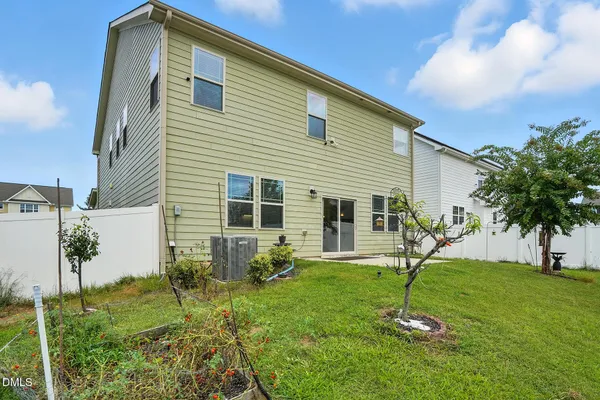 a view of a house with a backyard