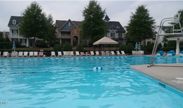 a view of a swimming pool with outdoor seating