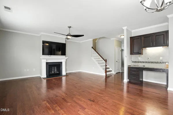 a view of a livingroom with furniture a flat screen tv and wooden floor